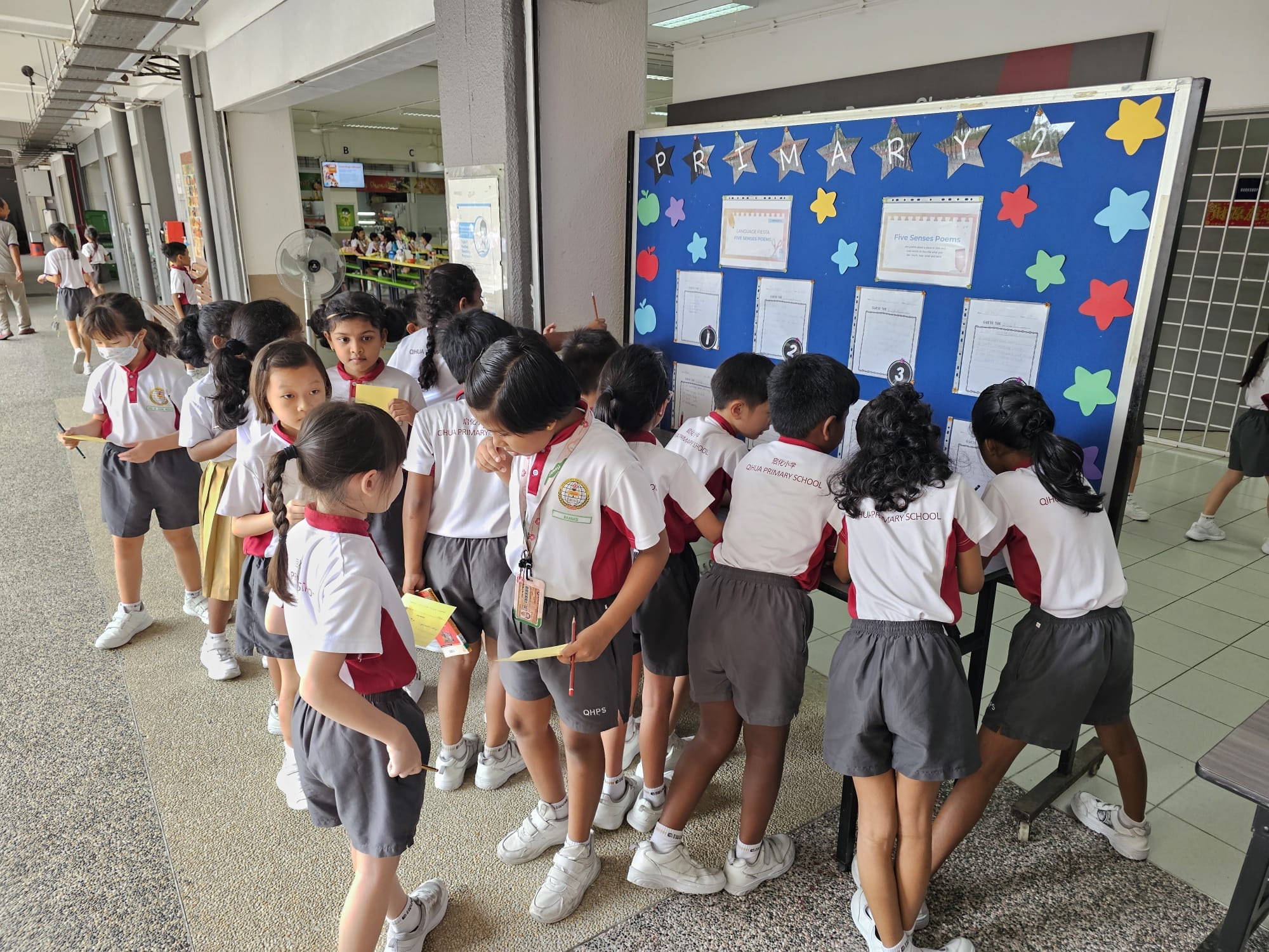Students gathering in the canteen to participate in a programme exhibition